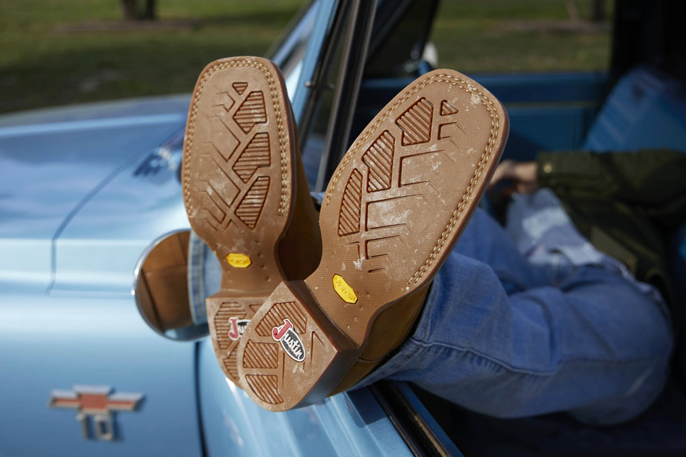 A close-up of the outsoles on a pair of Justin cowboy Boots.